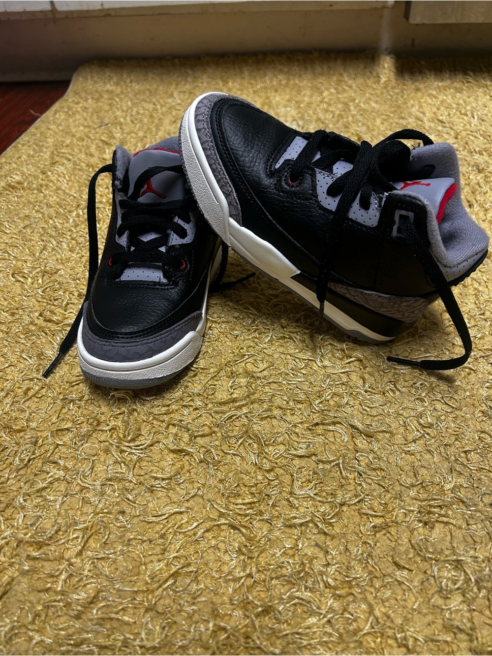 Nike Black , red and gray Jordan 3’s.